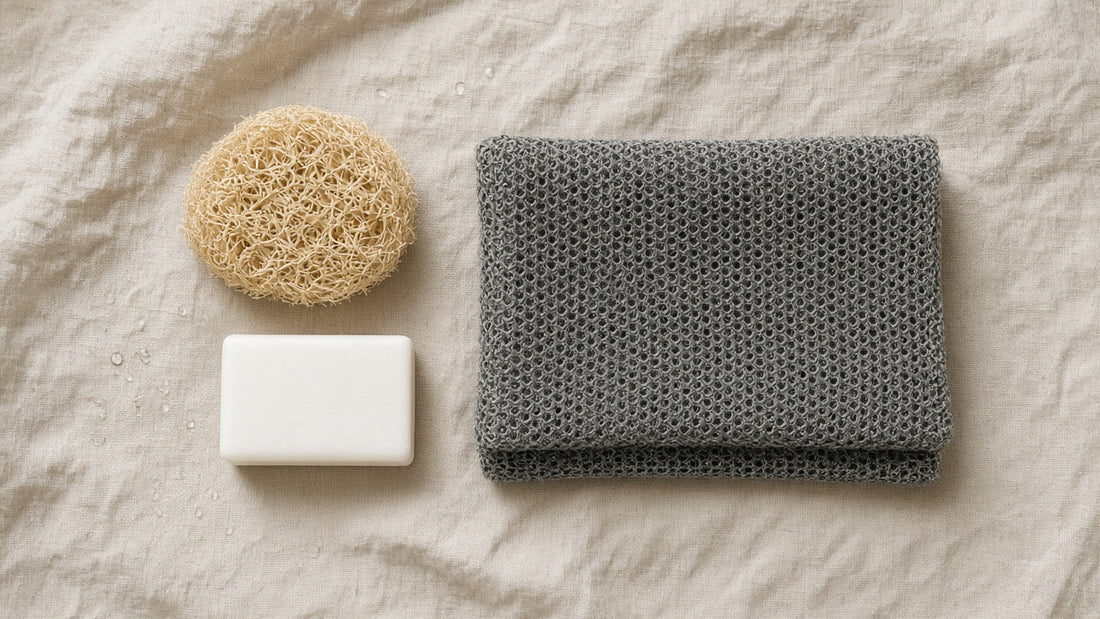 Flat lay comparing a natural loofah and soap with a folded dark exfoliating towel